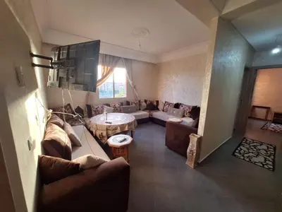 a living room with a couch and a table at Charming Apartment at Marrakech in Marrakech