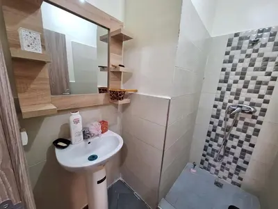 a small bathroom with a sink and a shower at Charming Apartment at Marrakech in Marrakech