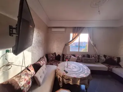 a living room with a couch and a table at Charming Apartment at Marrakech in Marrakech