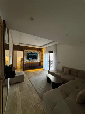 a living room with a couch and a table at Appartement Plaza Sunset in Marrakech