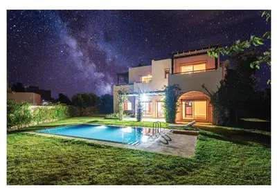 a house with a swimming pool at night at Villa Iris Jaccuzi, Piscine 20min Centre in Marrakech