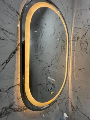 a mirror with a gold frame on a marble wall at Spacious Vibrant Apartment Marrakech Central - Prime Lifestyle Group in Marrakech
