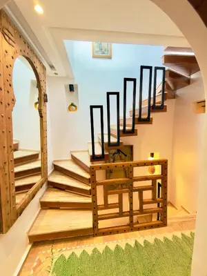 a set of stairs in a room with a table at Riad twaam in Marrakech