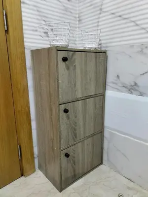 a wooden cabinet in the corner of a bathroom at Appartement Confort & Style à Charaf - Marrakech in Marrakech