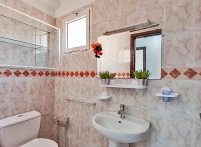 a bathroom with a sink and a toilet and a mirror at Modern 3BR Apartment 5 Min from Majorelle Garden in Marrakech