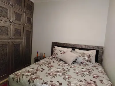 a bedroom with a bed with pillows on it at Joli et affordable appart pas loin de l'aéroport in Oulad Akkou