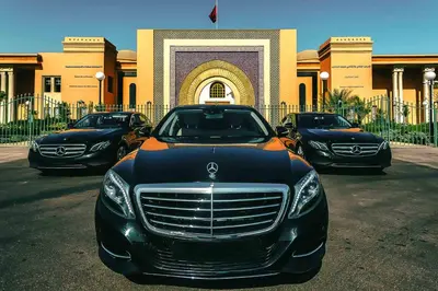 a black luxury car parked in front of a building at Car in Marrakech