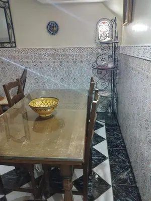 a dining room table with a bowl on it at Riad avec jardins et piscines in Marrakech