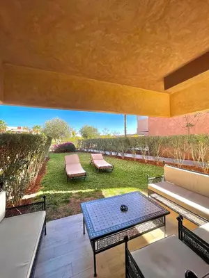 a patio with couches and a table and chairs at Prestigia golf in Marrakech