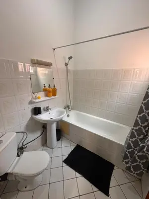a bathroom with a tub and a toilet and a sink at Riad Naïel piscine privée in Marrakech
