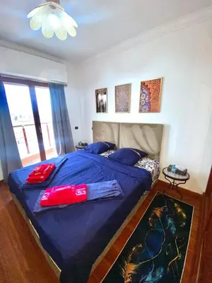 a bedroom with a blue bed with pillows on it at Modern Gueliz Apartment with Private Pool, Near to Train Station in Marrakech