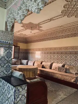 a living room with a couch and a table at 120m2, Centre Marrakech, Traditional in Marrakech