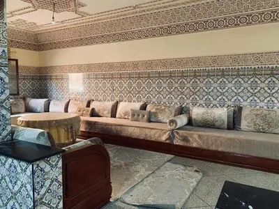 a living room with a couch and a table at 120m2, Centre Marrakech, Traditional in Marrakech