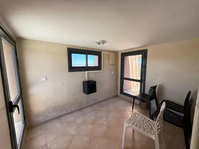 a living room with a tv and a table and chairs at Prestigious Villa in Marrakesh in Marrakech