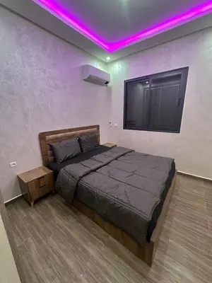 a bedroom with a bed with a purple lighting at Appartement cozy in Marrakech