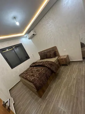a bedroom with a bed and a flat screen tv at Appartement cozy in Marrakech