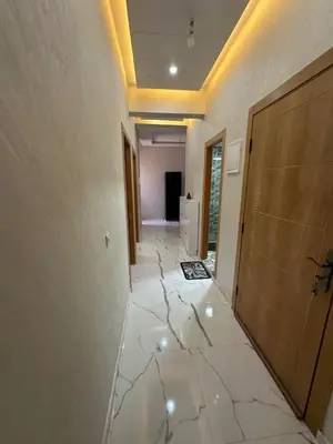 an empty hallway with marble floors and a door at Appartement cozy in Marrakech