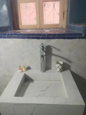 a white sink with a faucet in a bathroom at dar dmana in Marrakech