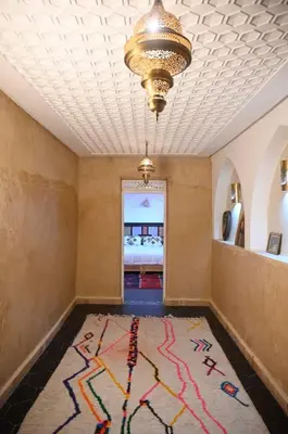a room with a rug on the floor and a chandelier at dar dmana in Marrakech