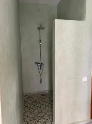 a corner of a room with a shower in the corner at Riad de luxe PAMA au cœur de la médina Marrakech in Marrakech