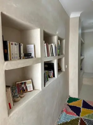 a room with shelves with books on the wall at Riad de luxe PAMA au cœur de la médina Marrakech in Marrakech