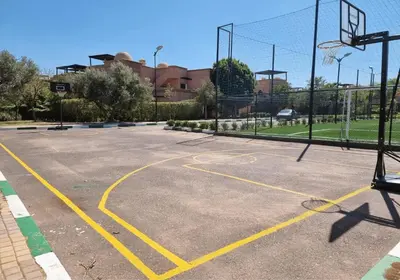 an empty basketball court with a basketball hoop at Golden Palms Marrakech in Marrakech