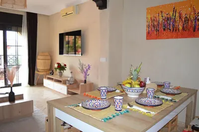 a room with a table with bowls of fruit on it at Golden Palms Marrakech in Marrakech