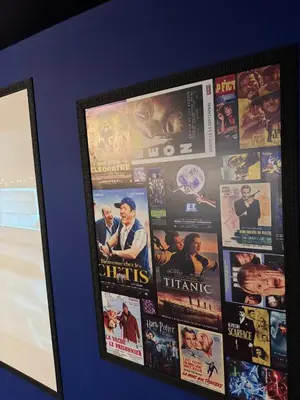 a framed picture of movie posters on a wall at Magnifique Villa piscine chauffée, cinéma et salle de fitness privés in Marrakech