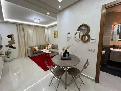 a living room with a table and a couch at Cozy and convenient apartment in Marrakech