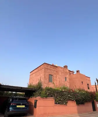 a car parked in front of a brick building at Villa Oasis Marrakesh in Marrakech