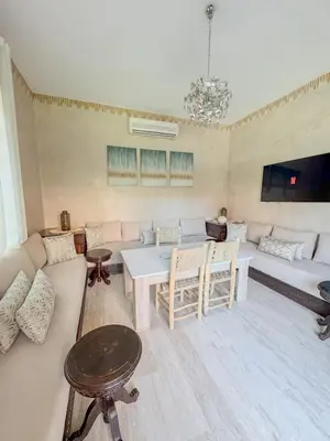 a living room with a couch and a table at Villa Oasis Marrakesh in Marrakech