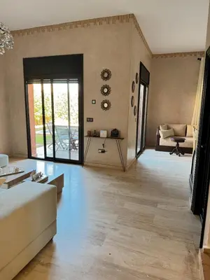 a living room with a couch and a table at Villa Oasis Marrakesh in Marrakech