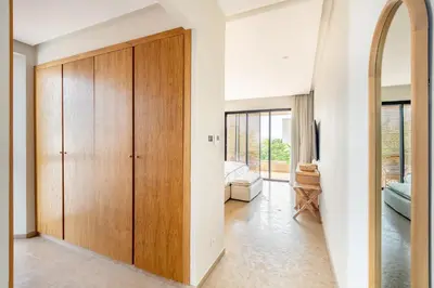 a hallway with a wooden closet and a living room at Villa Aila Elegant 6 Bedrooms Spa, Cinema Pool in Marrakech