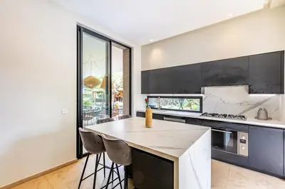 a kitchen with a large island with a counter top at Villa Aila Elegant 6 Bedrooms Spa, Cinema Pool in Marrakech