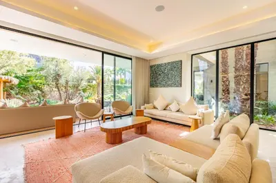 a living room with a couch and a table at Villa Aila Elegant 6 Bedrooms Spa, Cinema Pool in Marrakech