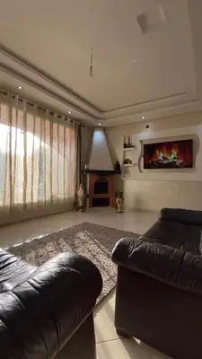 a living room with a couch and a fireplace at Espace Dar Es Saadâ in Marrakech