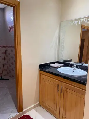 a bathroom with a sink and a mirror at Espace Dar Es Saadâ in Marrakech