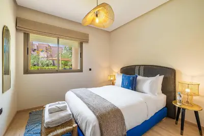 a bedroom with a large bed and a window at Charme Marrakchi - Piscine, Jardin & Espace Sport in Marrakech
