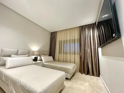 a hotel room with two beds and a window at Prestigia Marrakech luxury 015 in Marrakech