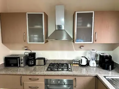 a kitchen with a stove top oven next to a sink at Appartement charmant au cœur de Marrakech in Marrakech