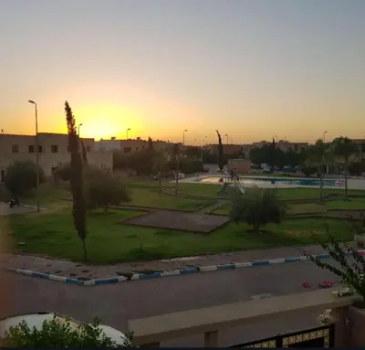 a view of a park with the sunset in the background at Villa Marrakech avec Piscine in Marrakech