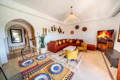 a living room with a red couch and a fireplace at luxury gueliz in Marrakech