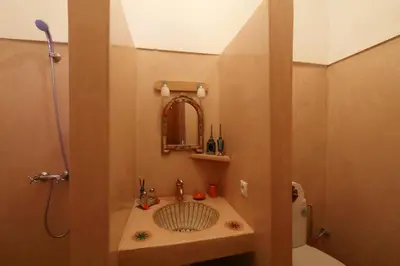 a small bathroom with a sink and a shower at Naima's House in Marrakech