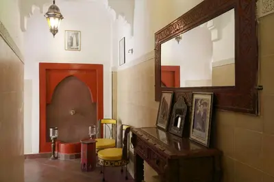 a room with a mirror and a table and chairs at Naima's House in Marrakech