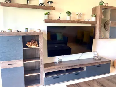 a large entertainment center with a television in a living room at Prestigia aghat in Marrakech