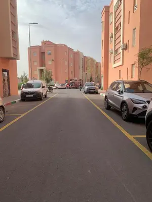 an empty street with cars parked on the side of the road at Spacious apartment 15 minutes from aéroport Marrakech reservation juste pour les familles est les couples mariés in Marrakech