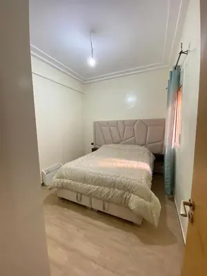 a bedroom with a bed in a room at Spacious apartment 15 minutes from aéroport Marrakech reservation juste pour les familles est les couples mariés in Marrakech