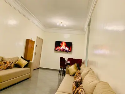 a living room with a couch and a table at Spacious apartment 15 minutes from aéroport Marrakech reservation juste pour les familles est les couples mariés in Marrakech