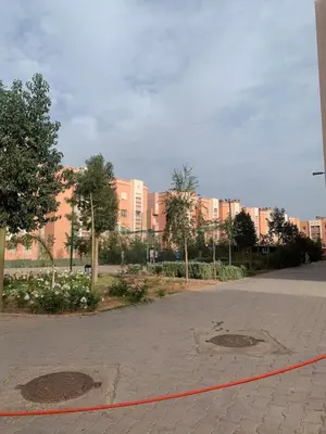 an empty street with buildings in the background at Spacious apartment 15 minutes from aéroport Marrakech reservation juste pour les familles est les couples mariés in Marrakech