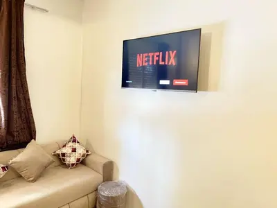 a living room with a couch and a tv on the wall at luxury marrakech in Marrakech